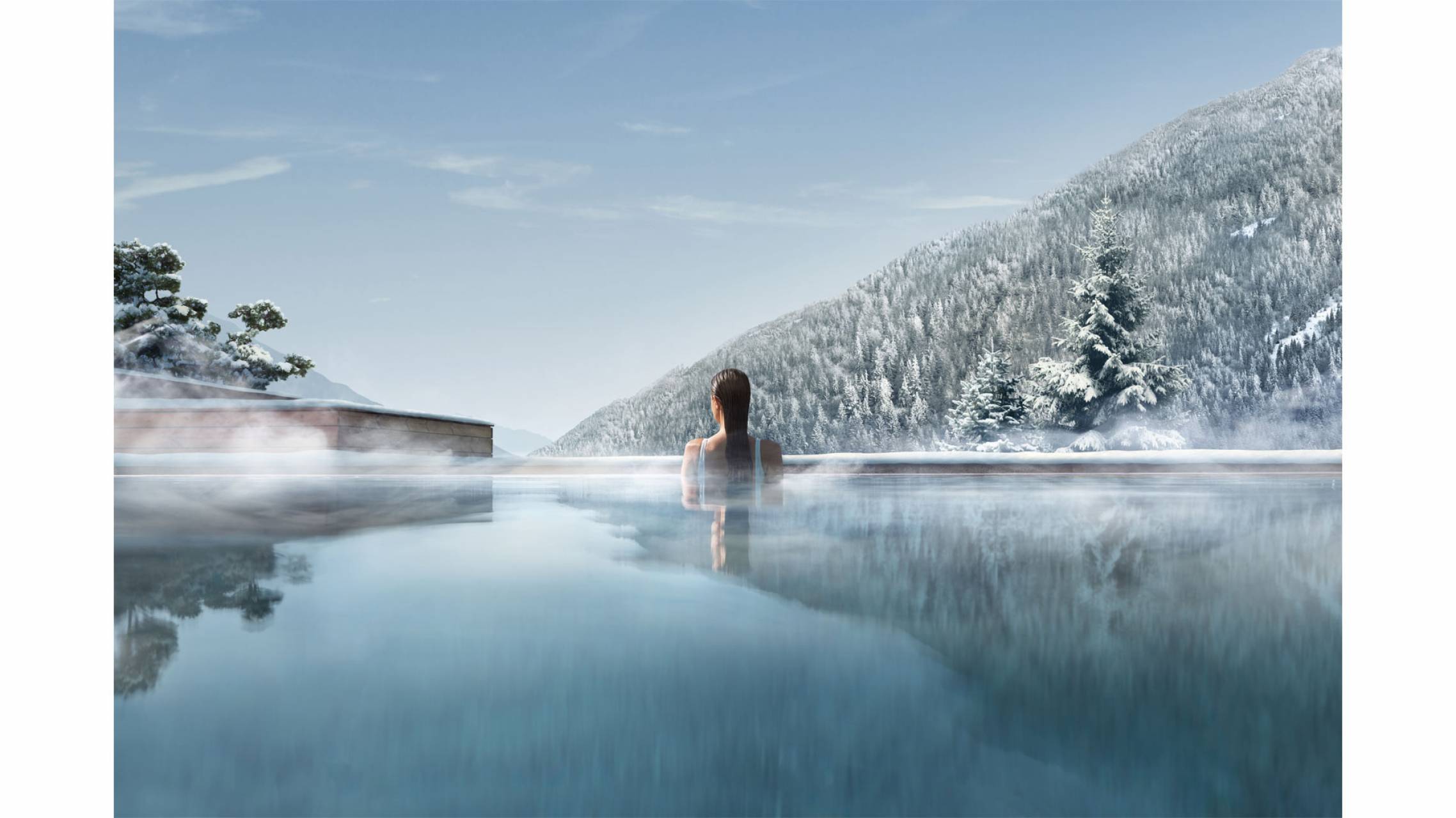 Outdoor pool with mountain view in a winter landscape 