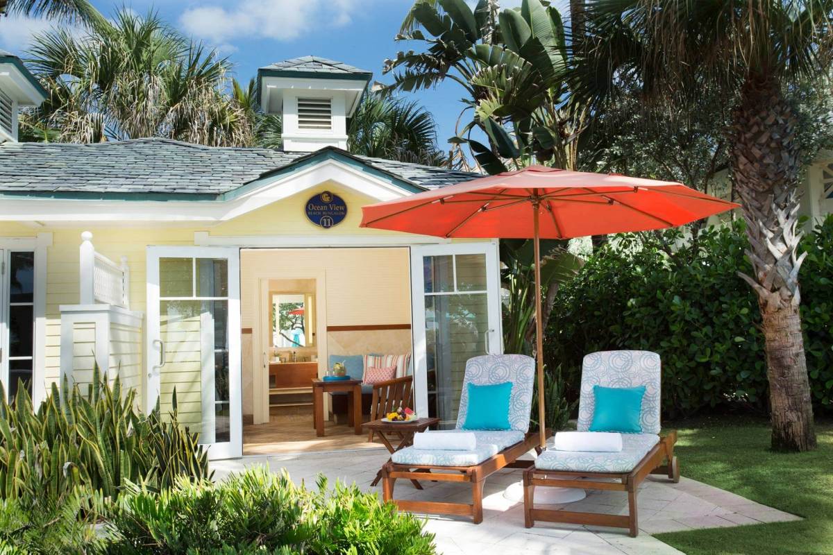 Two deckchairs in front of one of the beach bungalows at The Breakers