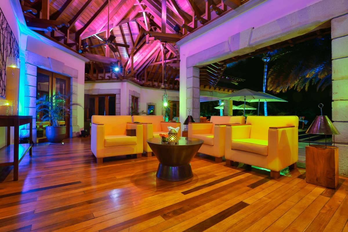 View into the colourfully illuminated inside of the Breakers Bar at Maradiva Resort