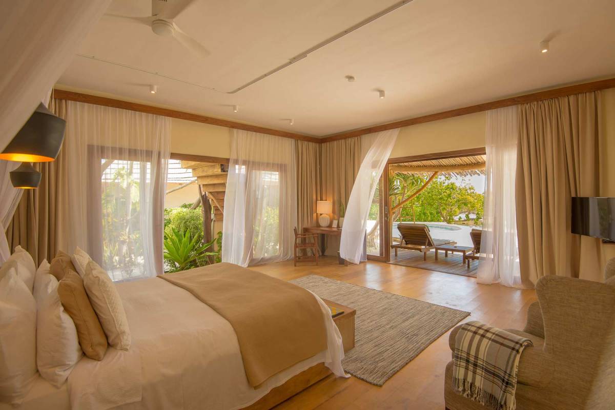 View on the bed at the ground level of one of the villas at Zanzibar White Sand with the terrace door open