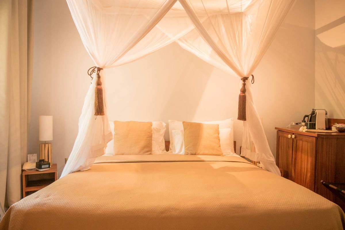 Close-up on the kingzise bed in one of the Cinnamon Rooms at Zanzibar White Sand